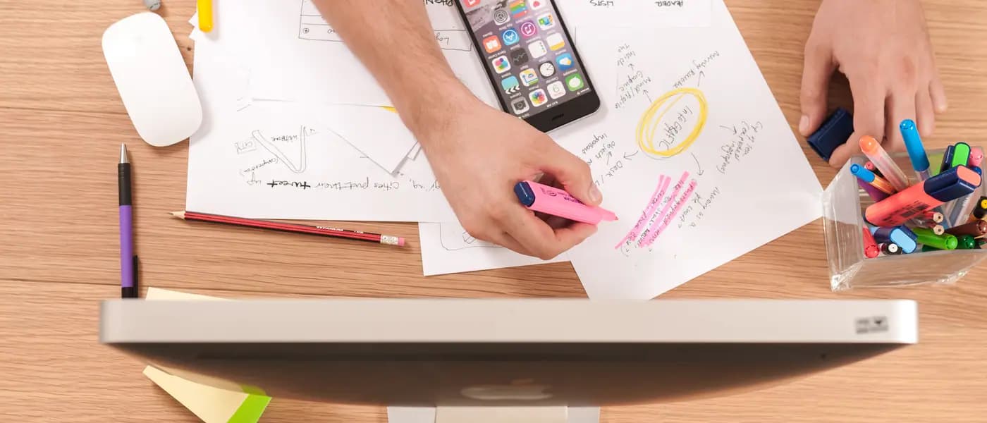 Marketing plan sketched on paper beside a phone for digital marketing services