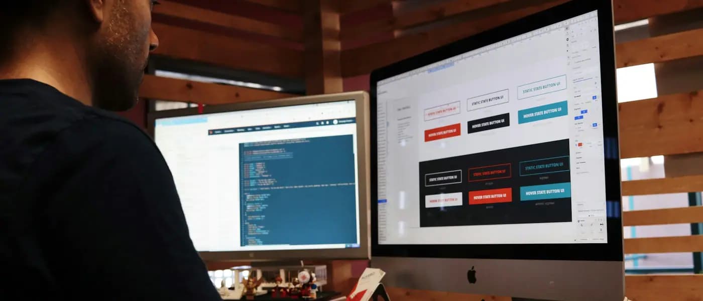 Designer building a website on a desktop monitor for healthcare website development