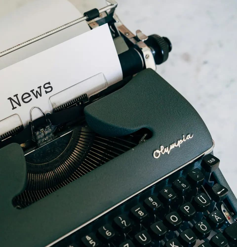 Typewriter with a page headed News representing press release distribution services