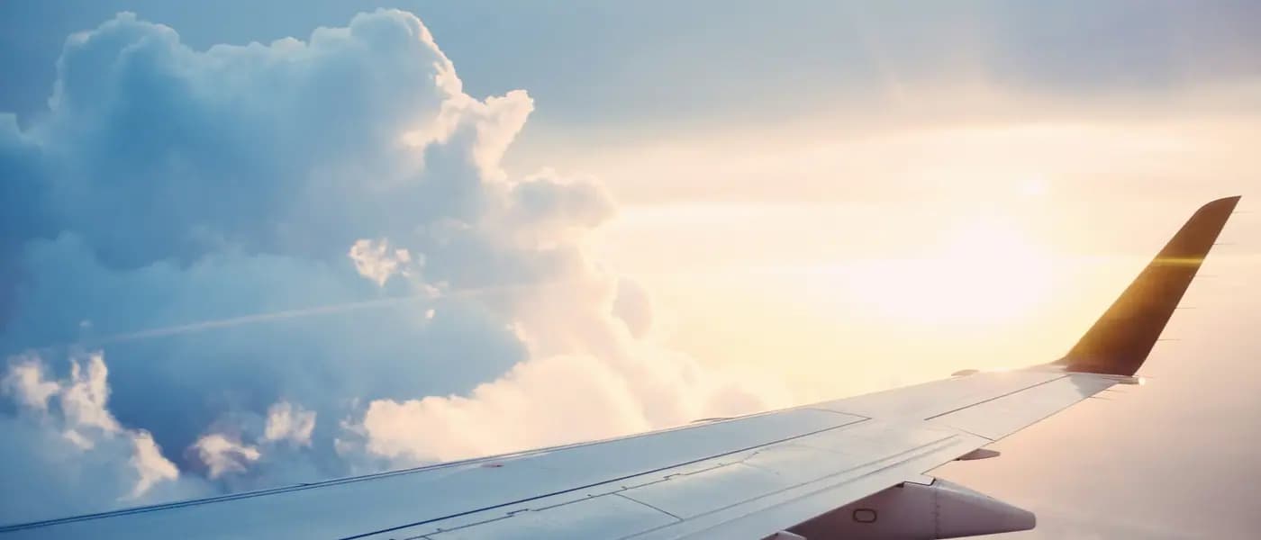 Aeroplane wing above the clouds for visa PR services