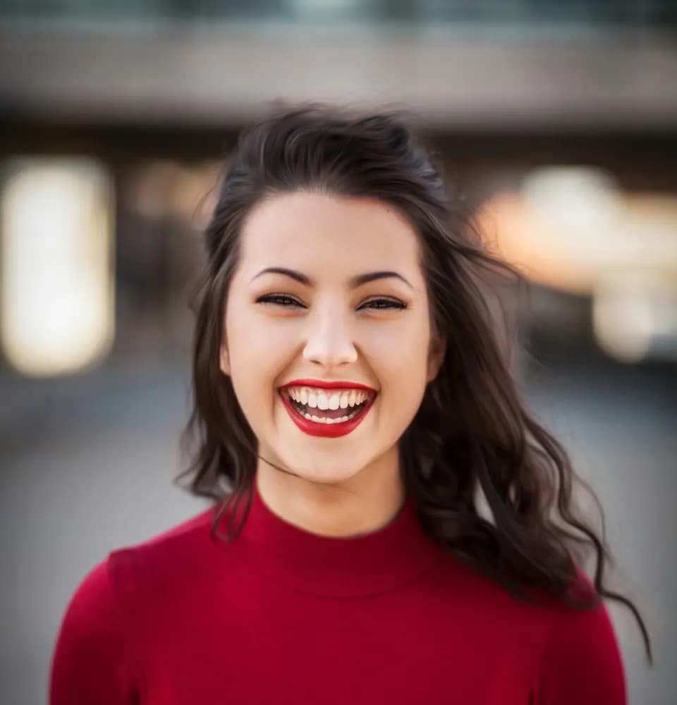 Smiling woman in a red jumper representing astrologer personal branding